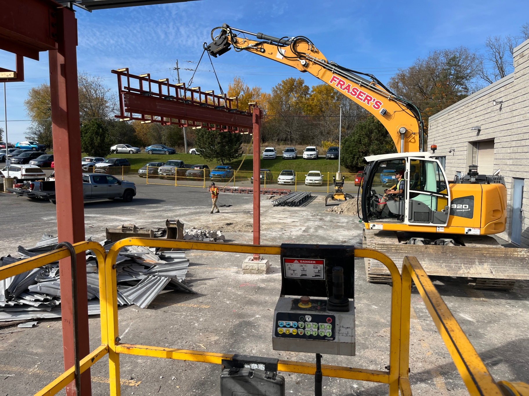 Fraser's excavator lifting a steel beam during commercial dealership demolition