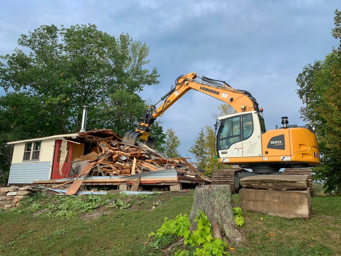 Fraser's Liebherr 920 excavator demolishing an old cottage