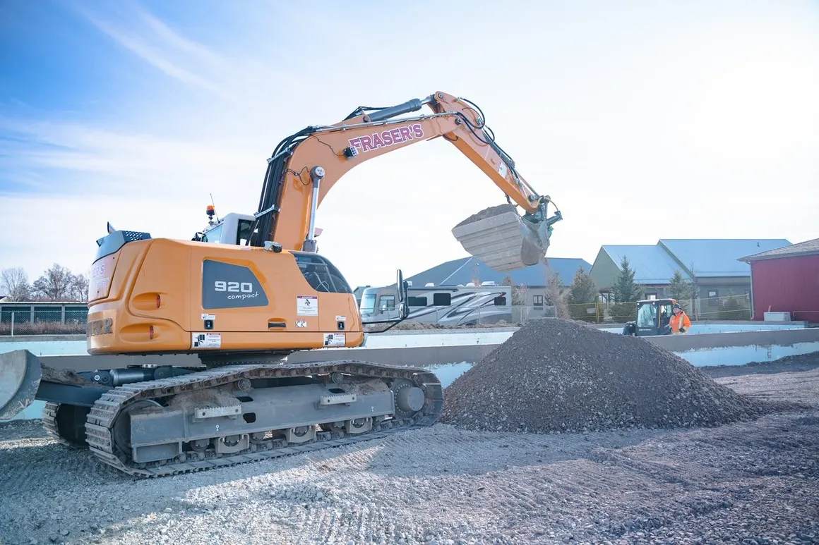 Fraser's branded compact excavator working on a foundation site